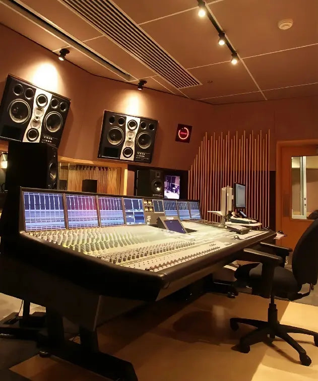 Professional recording studio with mixing console and monitor speakers.